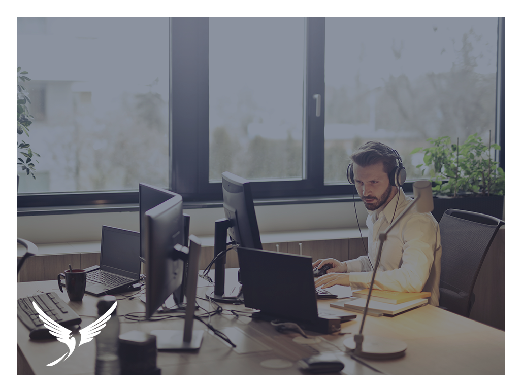 Man working at computer with headphones on