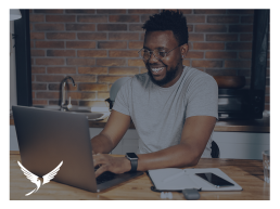 Man smiling at his laptop