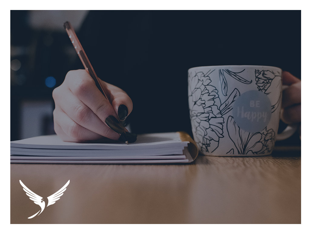 Woman writing with a cup of tea